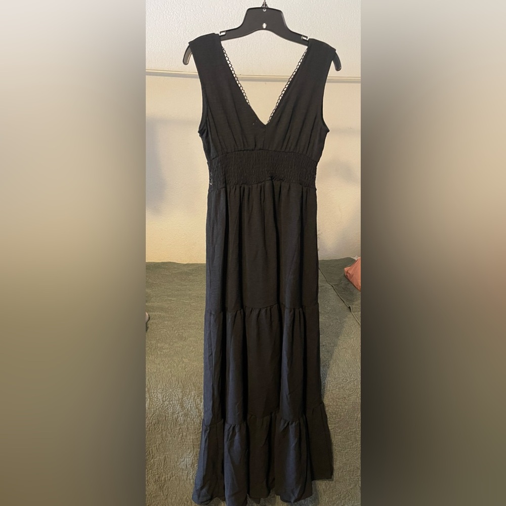 Black sleeveless dress. Lace detail at neckline and along bust line. NWT